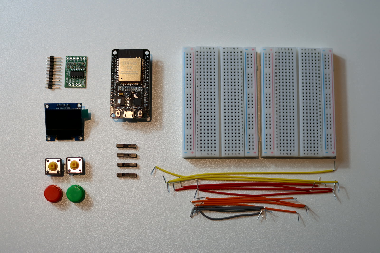 Every component laid out before assembly: ESP32, load cell, HX711, OLED, buttons, breadboards and wires