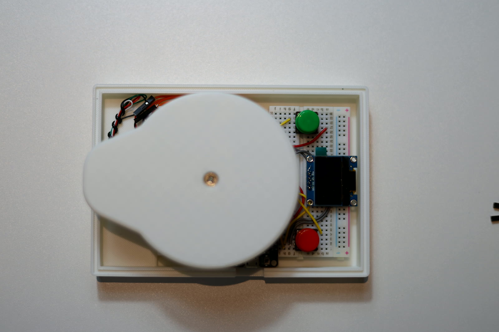 The round weighing platform installed over the electronics